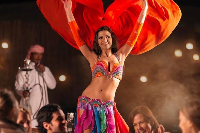 tourists enjoying belly dancing show in evening safari dubai