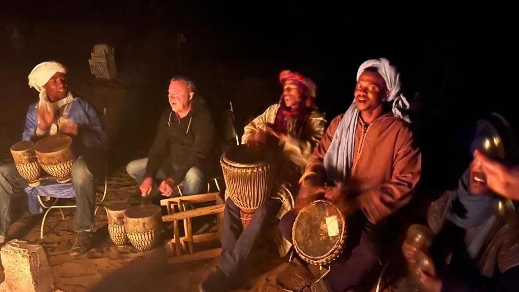 tourists enjoying drumming in evening safari dubai