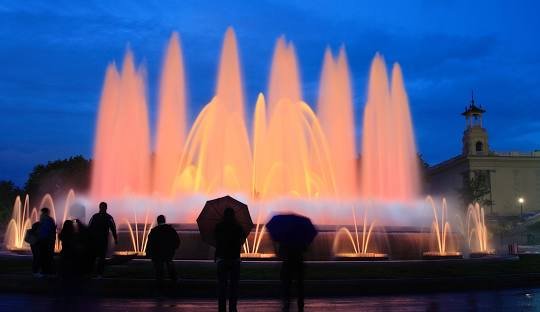 tourists enjoying the sight of magic fountain in barcelona