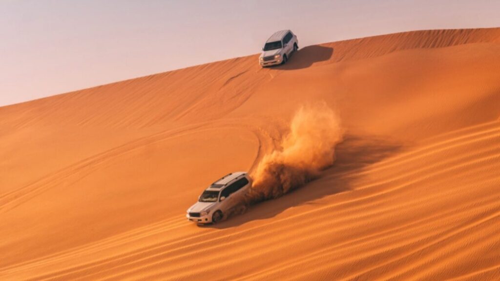 4x4 dune bashing adventure during Abu Dhabi Desert Safari United Arab Emirates at sunset