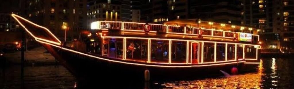 Guests relaxing and enjoying shisha on the upper deck of a dhow boat in Dubai.