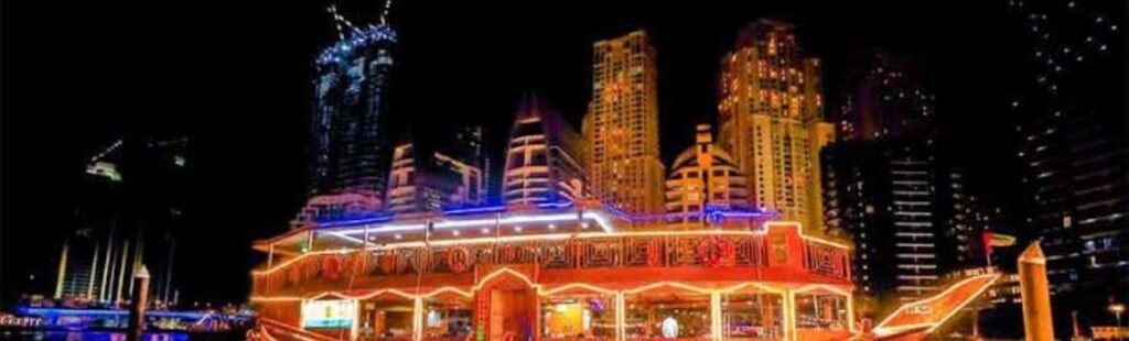 Guests boarding a traditional dhow boat for a dinner cruise in Dubai.