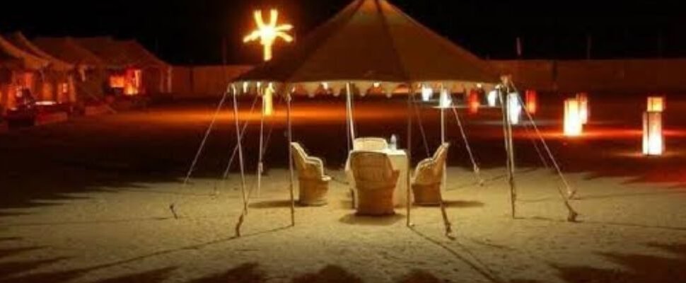 Guests enjoying a traditional Arabic dinner at a desert camp in Dubai.