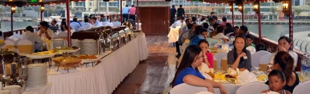 Guests enjoying live entertainment on a Marina Dhow Dinner Cruise.