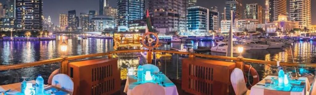 Night view of a Marina Dhow Dinner Cruise illuminated in Dubai.