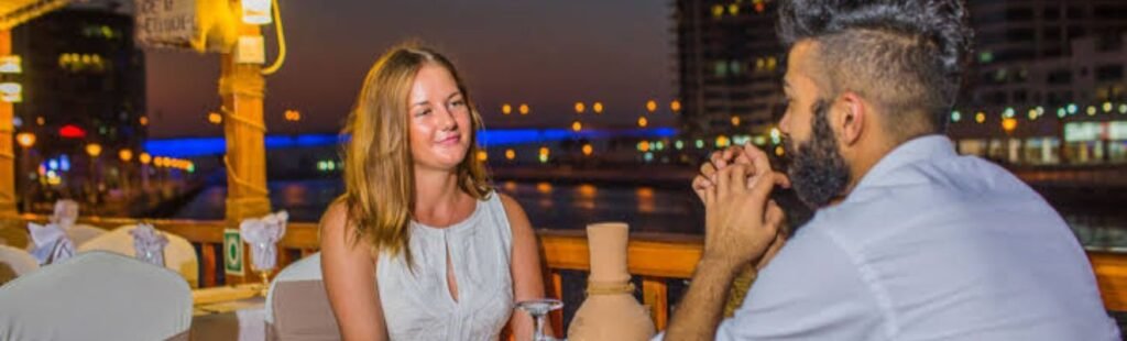 Guests admiring Dubai's skyline from a Marina Dhow Cruise with Dinner.