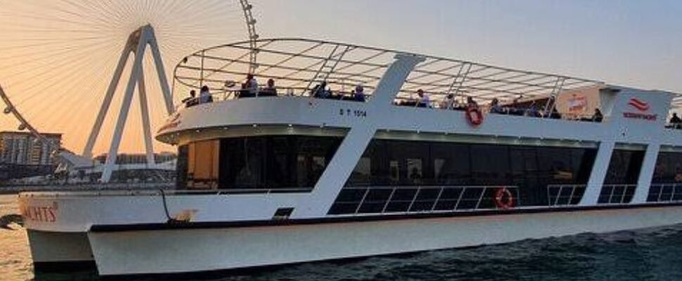 Marina Dhow Cruise with Dinner sailing against Dubai skyline.