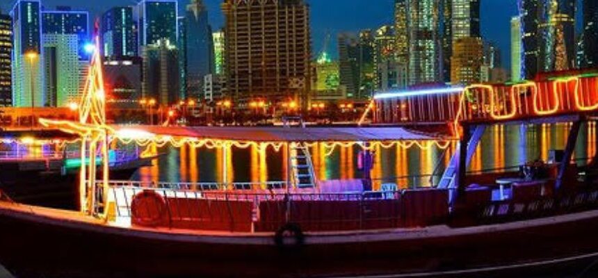 Dhow Marina Cruise sailing in Dubai at sunset.