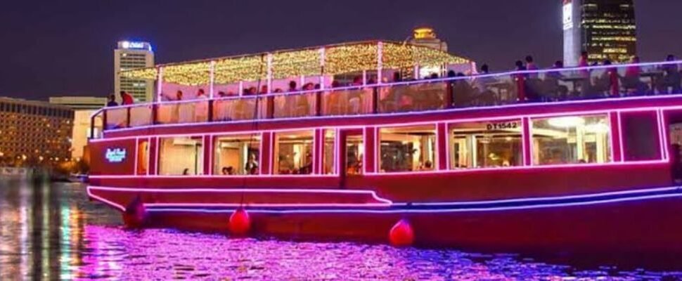 Dhow Cruise sailing on Dubai's illuminated waterways.