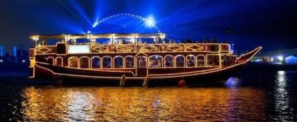 Dhow Cruise sailing on Dubai's waterways at sunset.