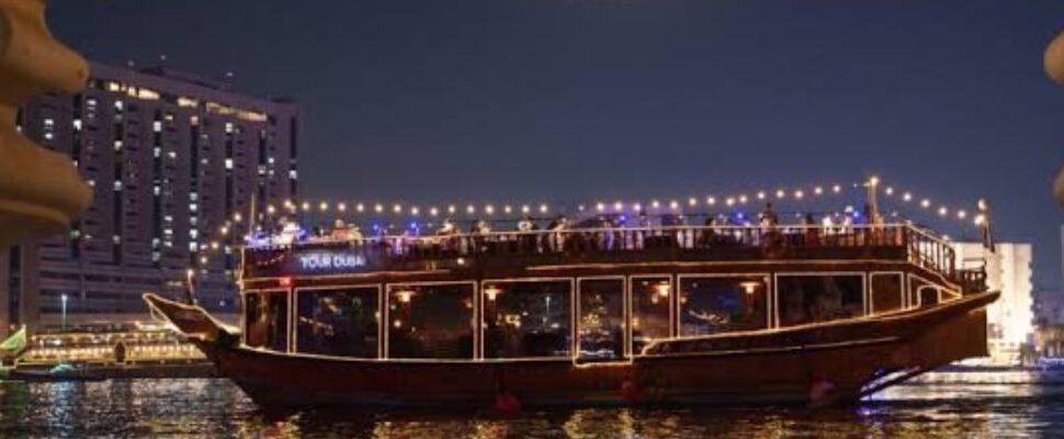 Dhow Cruise sailing on Dubai Marina waters at sunset.