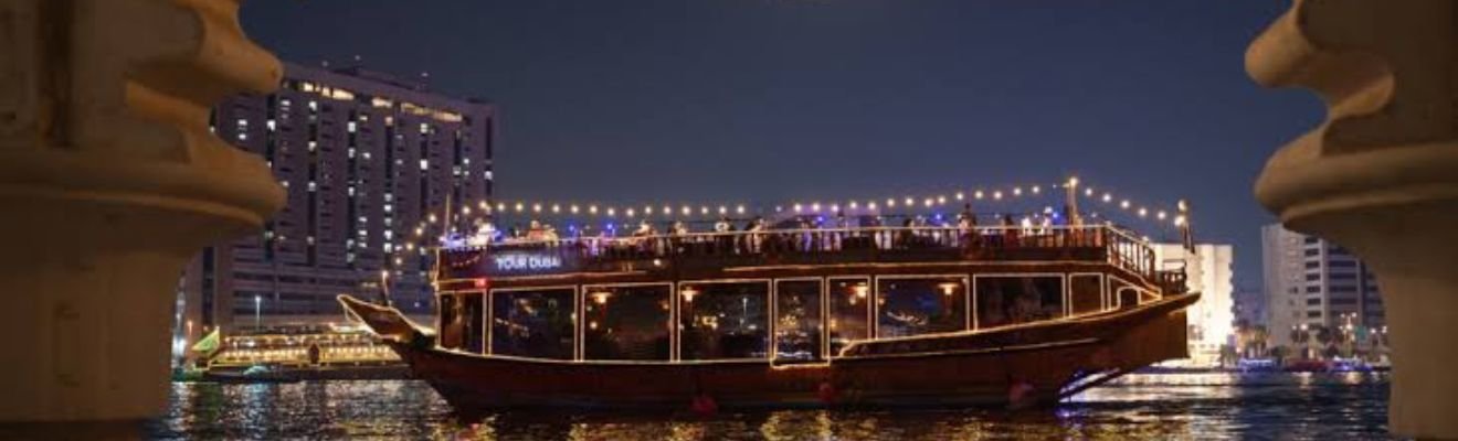 Dhow Cruise sailing on Dubai Marina waters at sunset.