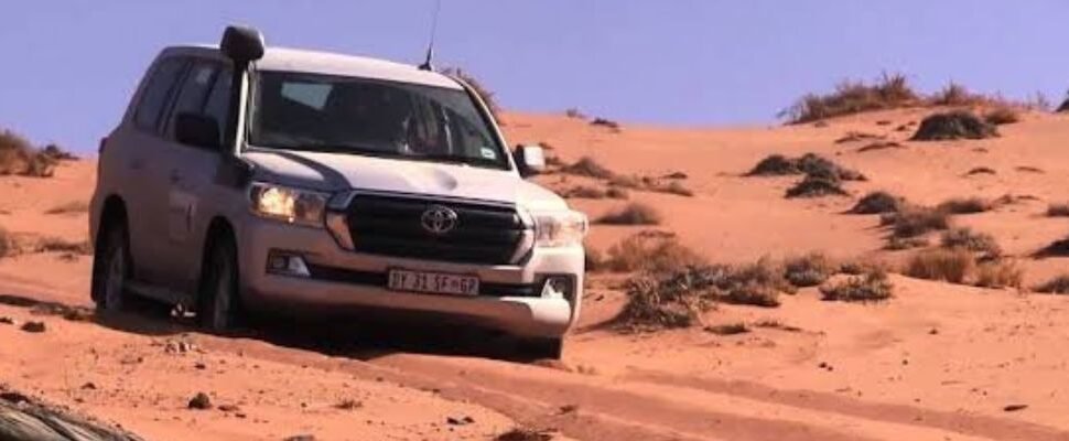 Desert Safari vehicle in Dubai's desert at sunset.