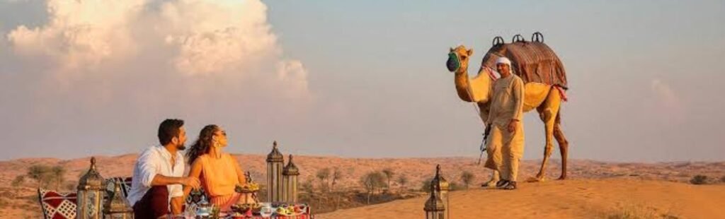 Guests sandboarding on Dubai's desert dunes.