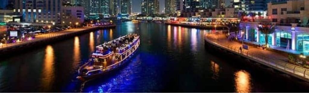 Night view of a Dhow Cruise Dinner illuminated in Dubai.