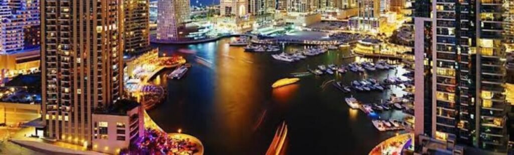 Night view of a Dhow Cruise Marina illuminated in Dubai.