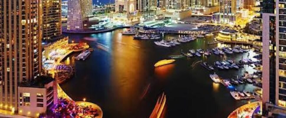 Dhow Cruise Dinner in Dubai with city skyline in the background.