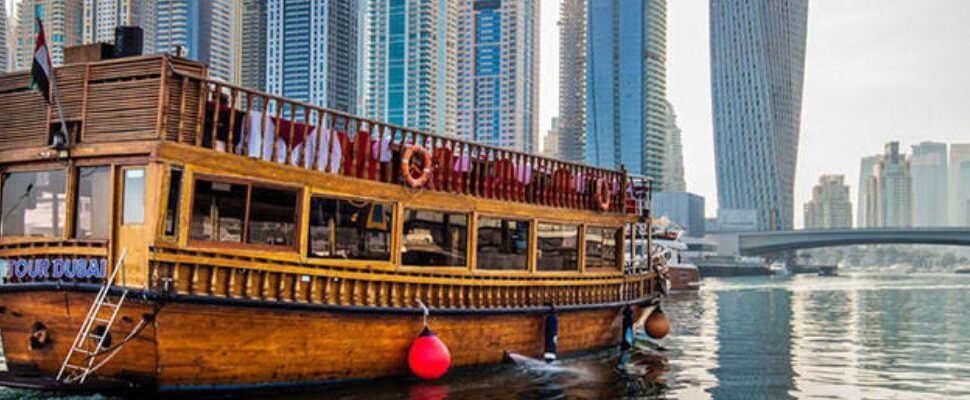 Dhow Cruise sailing on Dubai's waters at sunset.