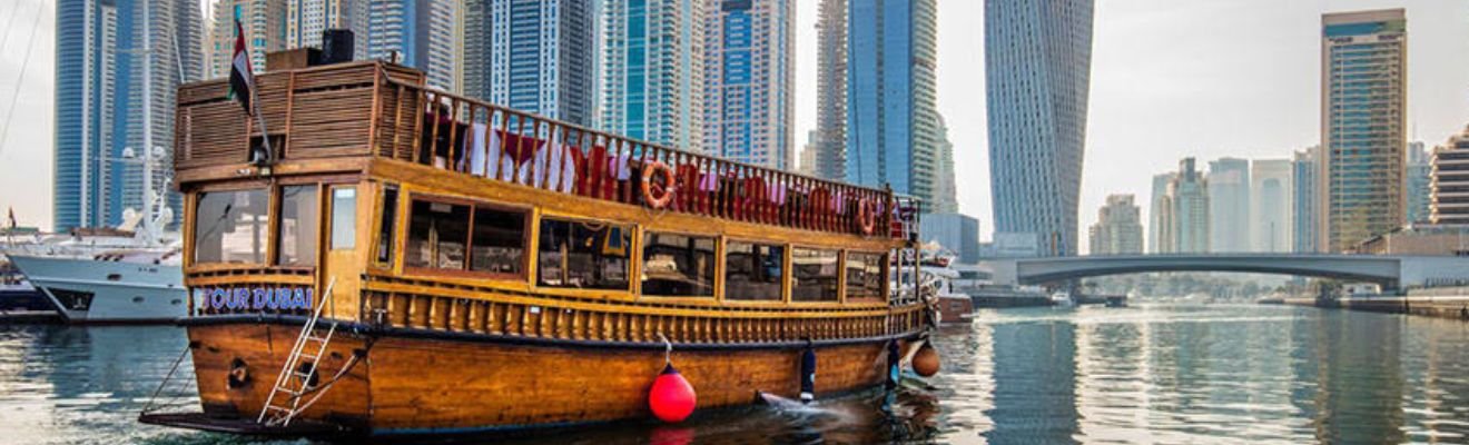 Dhow Cruise sailing on Dubai's waters at sunset.