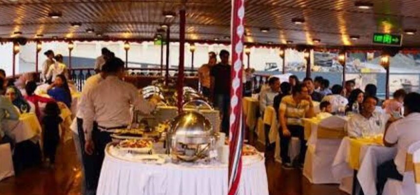 Dhow Cruise sailing on Dubai's waters at sunset.