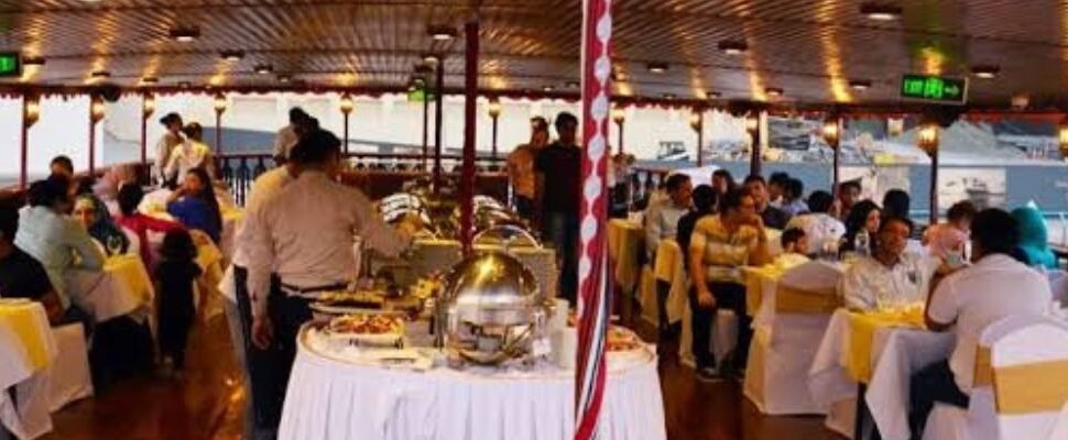 Dhow Cruise sailing on Dubai's waters at sunset.