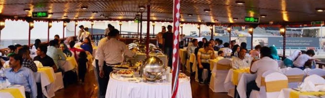 Dhow Cruise sailing on Dubai's waters at sunset.