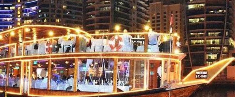 Arabian Dhow Cruise sailing with Dubai skyline.