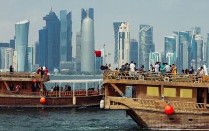 Dhow Cruise sailing on Dubai Creek at sunset.