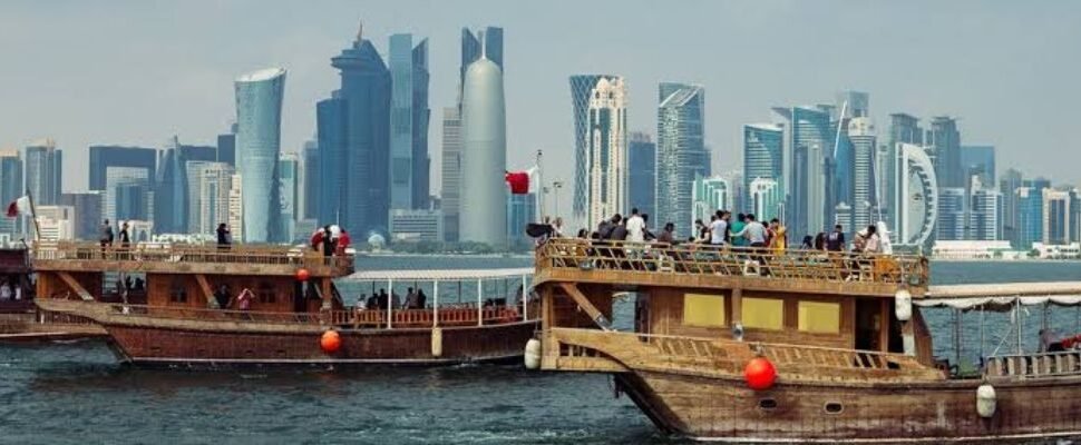 Dhow Cruise sailing on Dubai Creek at sunset.