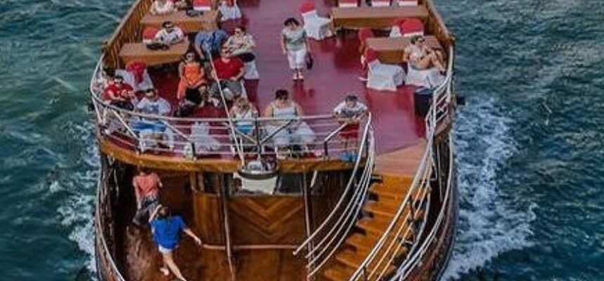 Dhow Dubai › Forever Tourism LLC Dhow Dubai sailing against the city skyline at sunset.
