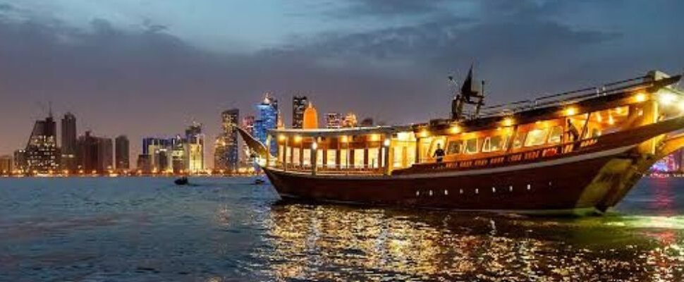 Luxurious boat cruising through Dubai Marina at sunset.