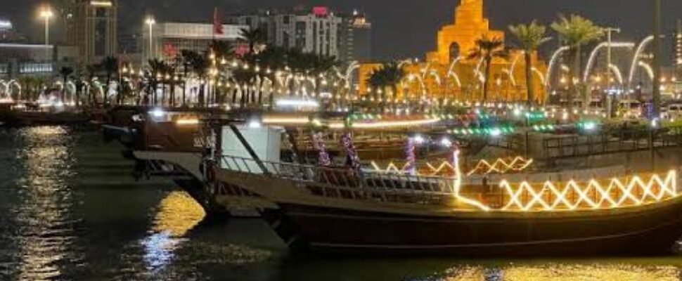 Boat sailing through Dubai Marina at sunset.