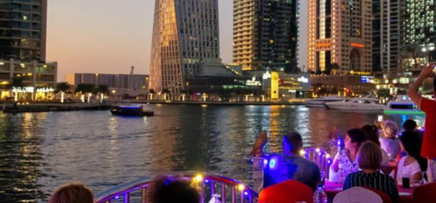 Dhow Cruise Dubai Creek Deals › Forever Tourism LLC Dhow Cruise sailing on Dubai Creek at sunset.