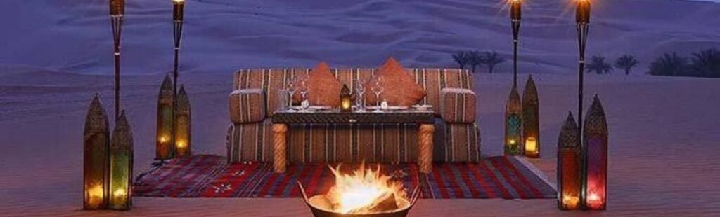 Guests enjoying a night-time BBQ dinner in the Dubai desert.