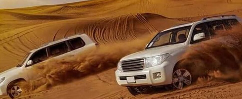 Safari 4x4 vehicle driving through Dubai's desert dunes.