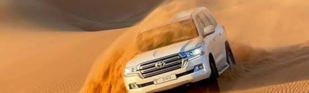 Guests riding camels in the Dubai Desert.