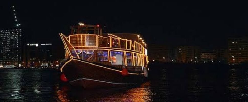 Dhow Cruise sailing against Dubai skyline.