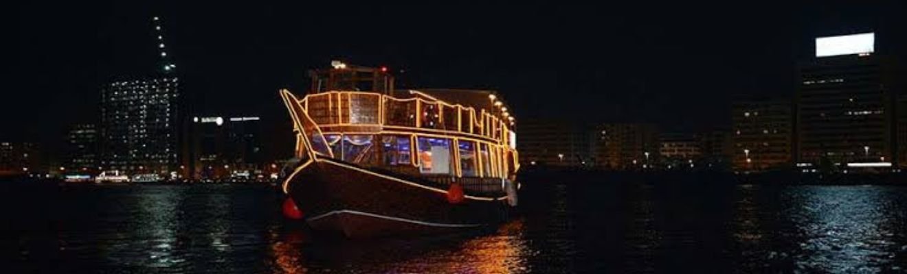 Dhow Cruise sailing against Dubai skyline.