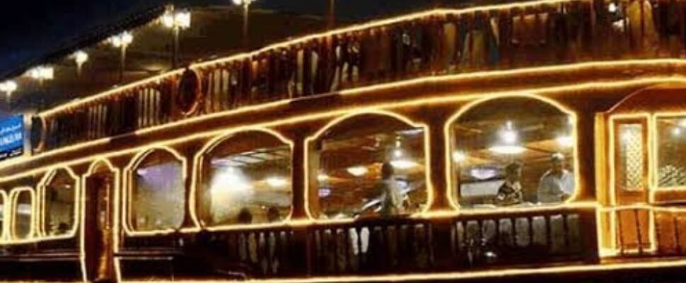 Dhow Cruise sailing through Dubai's waterways at sunset.