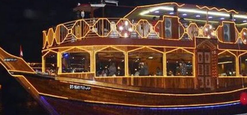 Dhow Creek › Forever Tourism LLC Traditional dhow boat sailing on Dubai Creek with city skyline.