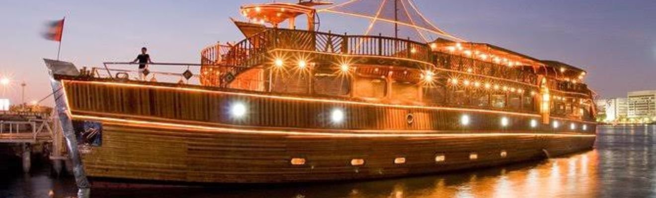 Luxury Dhow Cruise sailing on Dubai’s waters at twilight.