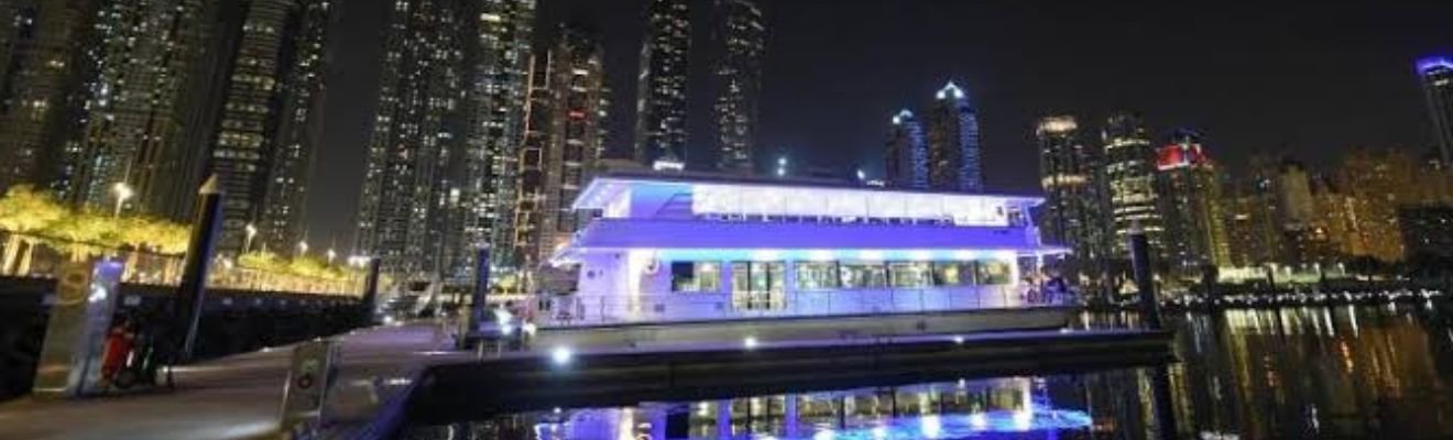 Luxury Marina Boat Cruise with Dubai skyline at sunset.