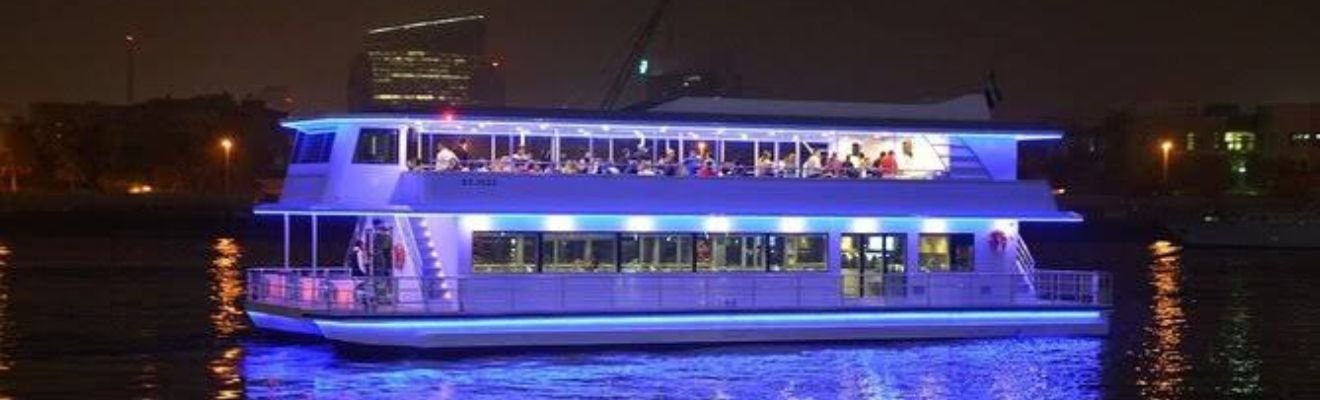 Luxury Marina Cruise boat with Dubai skyline in the background.