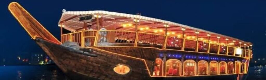 Couple enjoying the sunset from a wooden dhow boat.