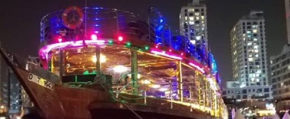 Dubai skyline illuminated at night from the water.