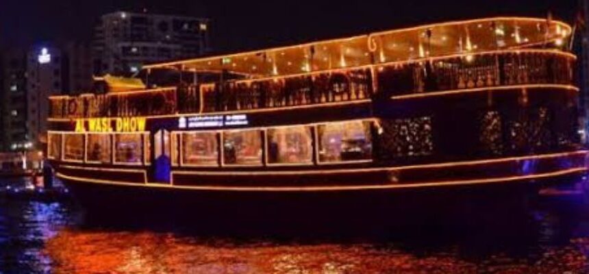Traditional dhow boat cruising through Dubai Canal.