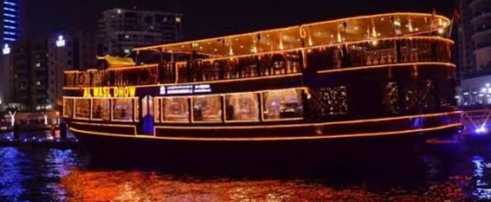 Traditional dhow boat cruising through Dubai Canal.