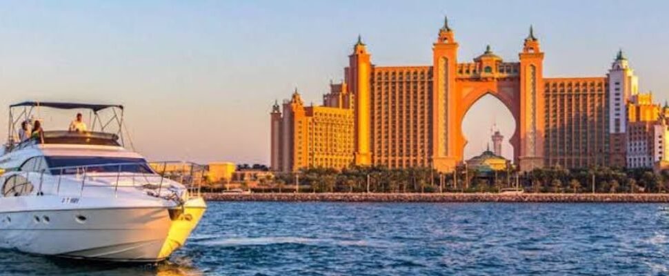 Luxurious private yacht at night on Dubai's waterfront.