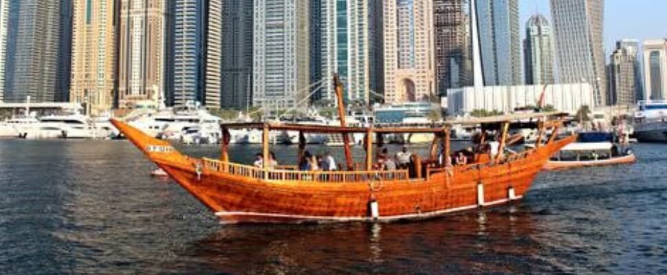 Elegant dhow cruise boat sailing along Dubai Creek.