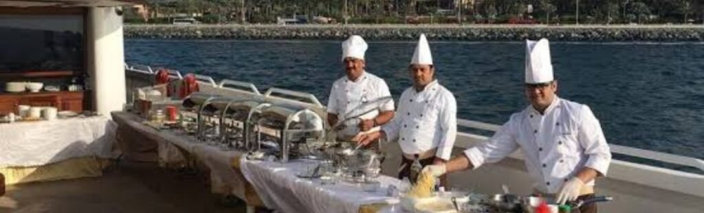 Elegant dining table setup on the yacht with a view of Dubai's skyline.